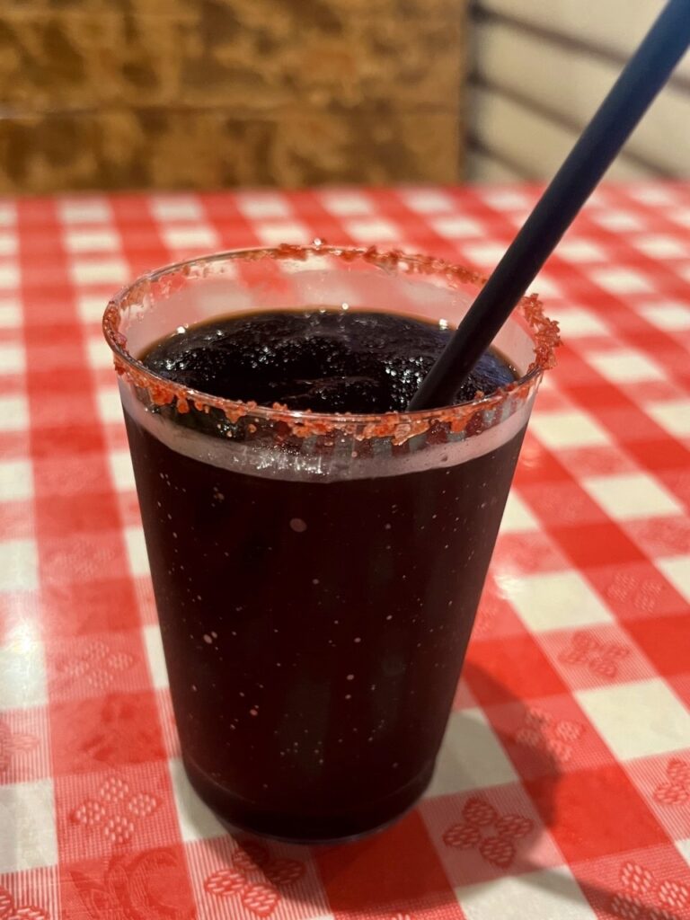 a black margarita with a red salt rim from Terry Black's BBQ restaurant