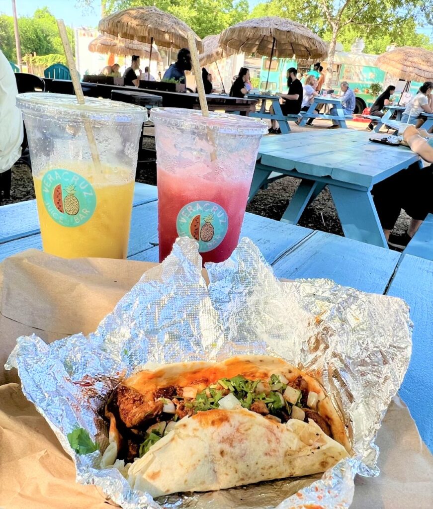 a taco and drinks in front of a food truck