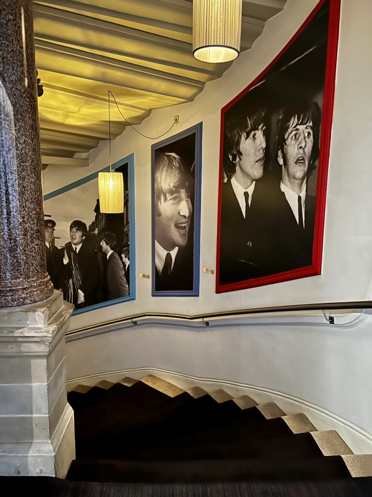 The staircase at a Beatles-themed hotel with portraits of the band