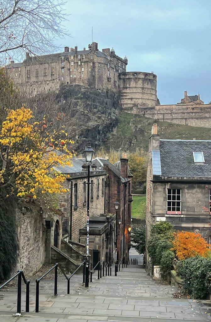 view from on top of a staircase and a castle on a hill in the distance