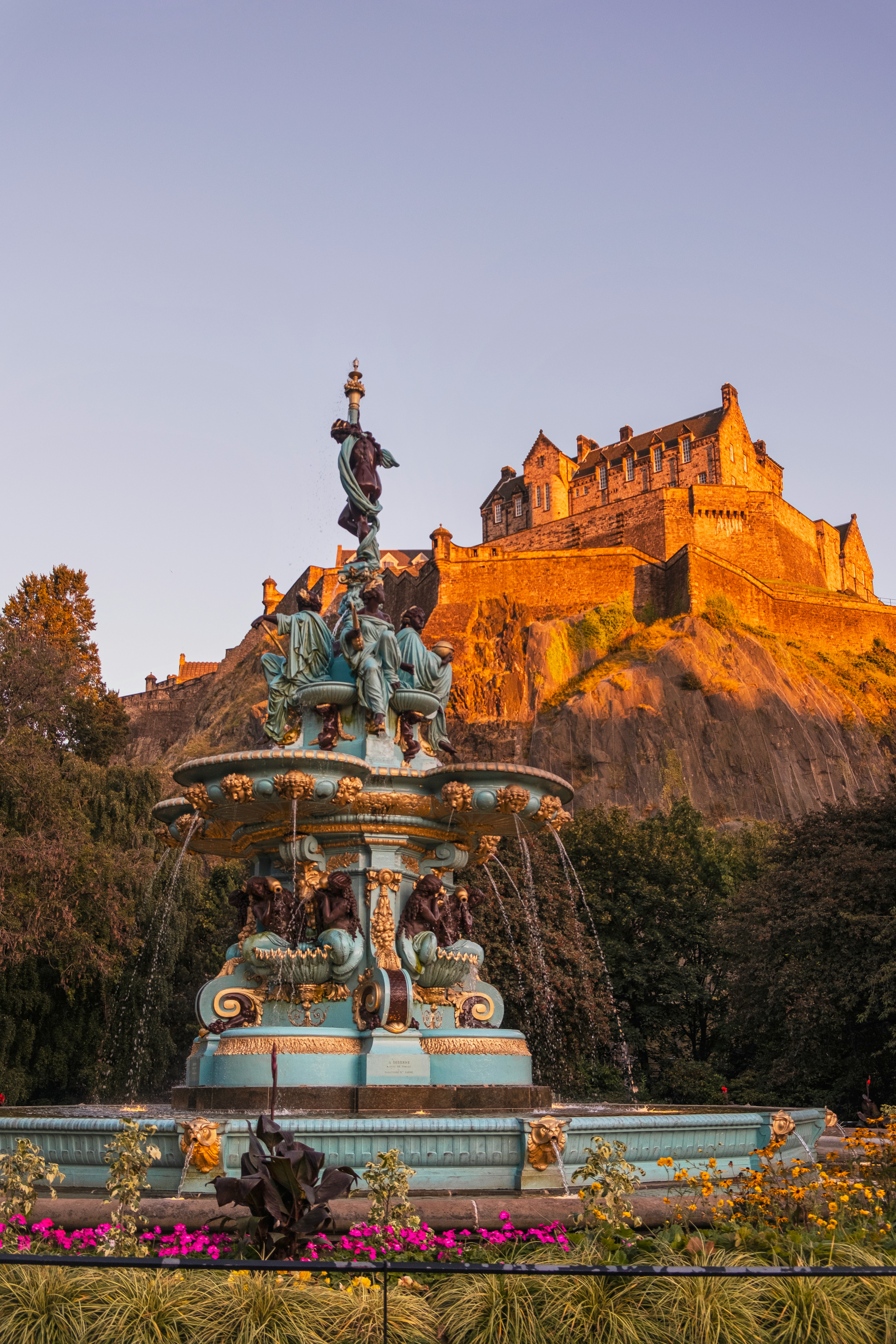 a fountain with a castle in the background